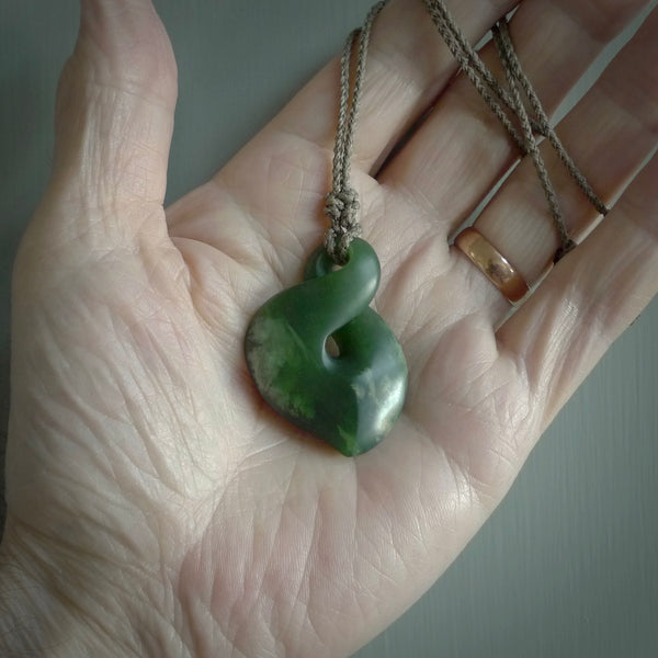 Hand carved medium sized, New Zealand jade twist pendant. Carved in New Zealand by NZ Pacific. Māori themed jewellery for sale online.