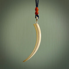 Hand carved incredible Huia bird beak woolly mammoth tusk carving. A stunning work of art, beautifully replicating a hula bird beak. This pendant was hand carved in mammoth tusk by artist Sami. A one off collectors item that has been hand crafted to be worn or displayed.