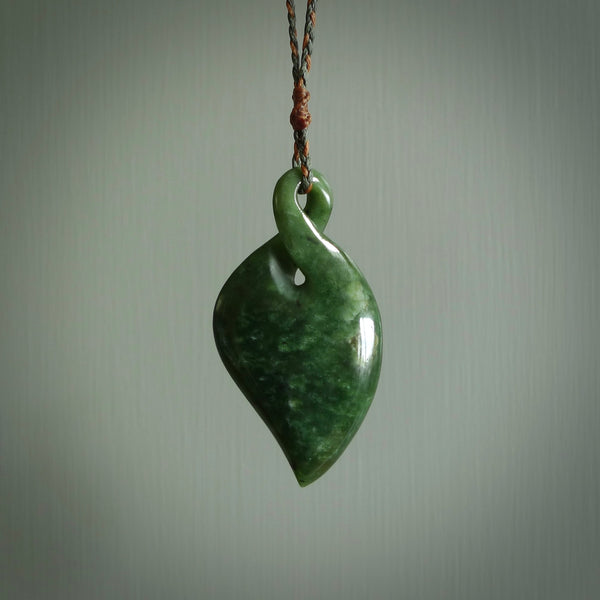 Hand carved New Zealand jade, single twist pendant. Maori pikorua pendant hand carved in New Zealand. Made by NZ Pacific, jade jewellery for sale online. One only hand made by Ross Crump.