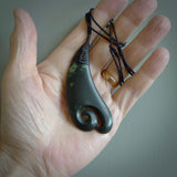 A hand carved large sized drop pendant with a koru carved into the front face. This is a piece of genuine jade jewellery, hand carved by Ric Moor. He has used New Zealand jade and has utilised his experience and carving skill to highlight the natural beauty of the stone. Delivered worldwide, postage is included in the price.