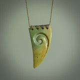 Hand carved New Zealand Flower jade niho, fang, pendant with Koru heart centre. Carved by New Zealand artist Ric Moor. Contemporary New Zealand Jade fang, drop necklace with Koru centre. One only unique pendant for men and women.