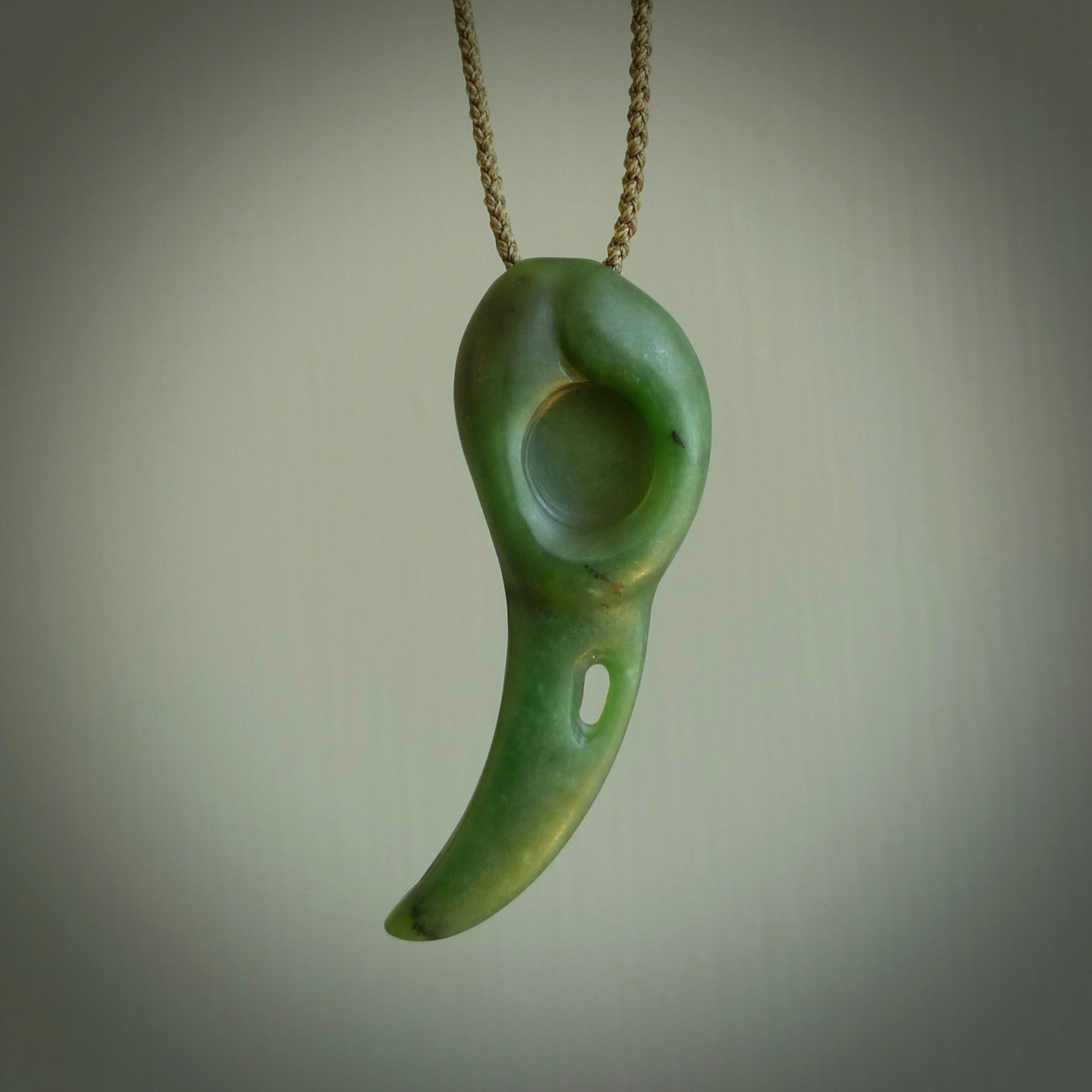 Hand carved huia bird skull made from New Zealand Marsden Jade pendant. Carved for NZ Pacific by Kyohei Noguchi. This is a contemporary piece of jewellery that is carved with intricate detail and clearly shows a beautiful bird skull. We ship this free worldwide with Express Courier.