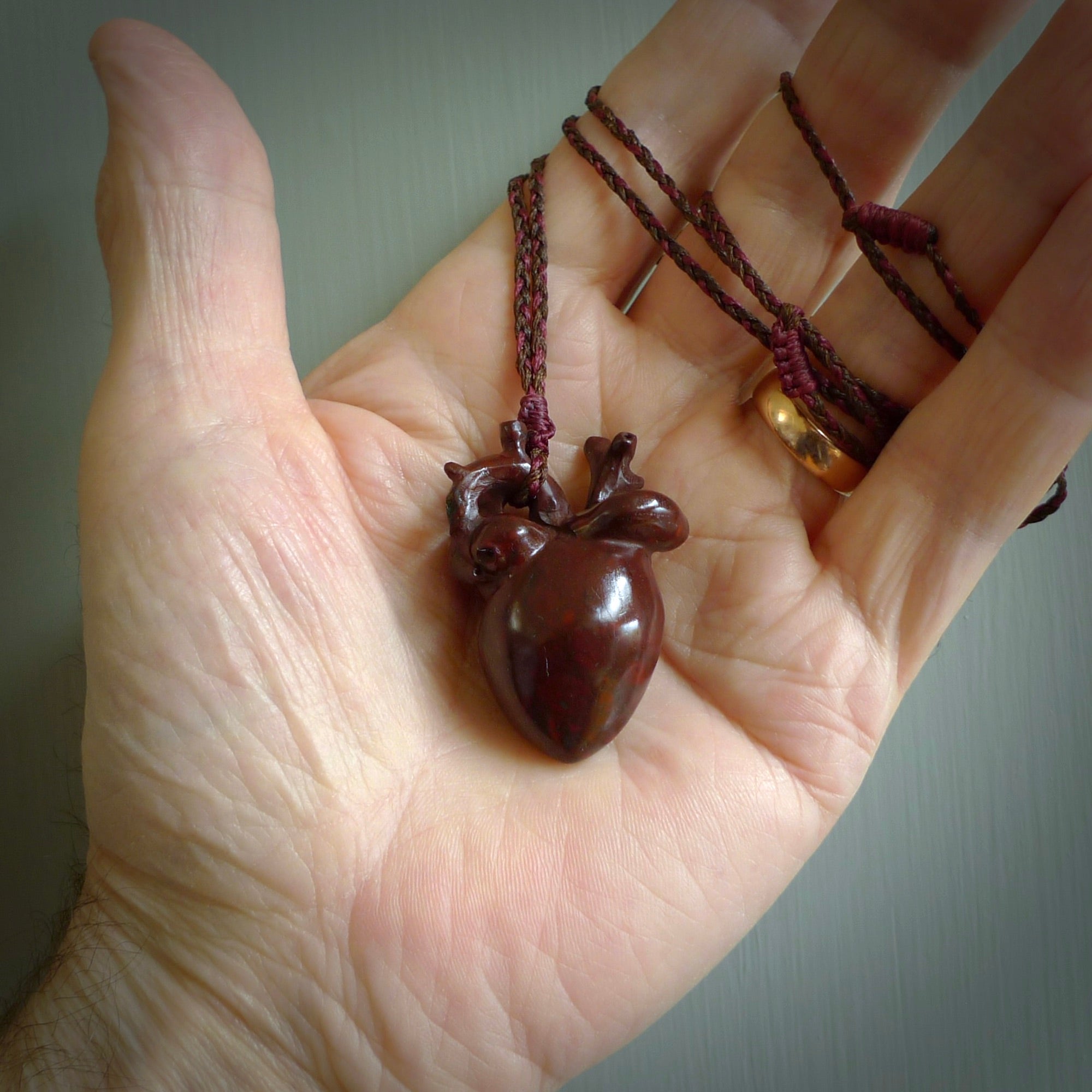 This pendant is handcrafted from Red Jasper Stone. It replicates a human heart. It is supplied with an adjustable burgundy/brown cord. It is a graceful and very interesting piece that will attract admiration and comment. Free Express Shipping.