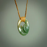 This pendant is a complex koru design. Carved in gorgeous New Zealand jade it is a medium sized pendant that can be worn by anyone. Hand made in New Zealand by NZ Pacific.