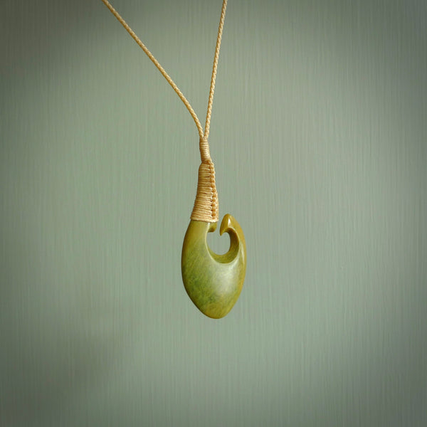 This matau, with koru, is carved from a very striking New Zealand jade. It is both intricate and simple in design - it has hidden folds and smooth curves. A piece to be worn or displayed - the carving and the jade are both magnificent. Hand made by Donna Summers.
