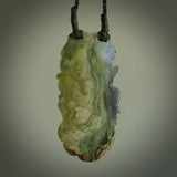 A photo of a New Zealand Jade praying pendant with . This is a one off, statement piece - hand crafted here in New Zealand by Jeremy. Unique Art to Wear. Gifts for all lovers of hand made Art to Wear. One only collectors pendant. Delivery is free worldwide. Included is a wooden box.