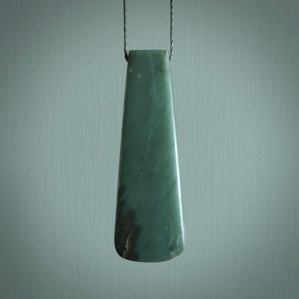 This photo shows a large jade drop shaped pendant. It a a lovely, colourful Inanga jade. The cord is a green colour and is adjustable in length. One only large, contemporary drop necklace from Jade, by Rueben Tipene.