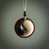 A hand carved and intricate yin and yang pendant made for us by Yuri Terenyi. This is a beautiful little piece and is emblematic of the well known and loved YIN & YANG design. It is carved from bone and buffalo horn. We have two available - one is suspended from an Ice White cord with a black floret and the other is suspended from an Black cord with Ice white floret. The necklace is adjustable.