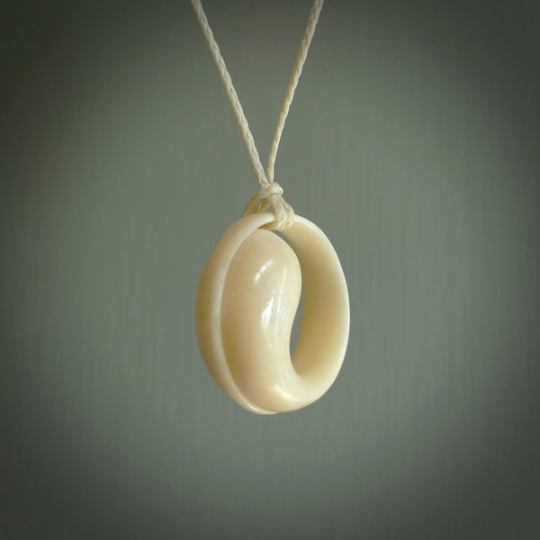 A hand carved masterpiece. A complex contemporary drop pendant carved from bone by Yuri Terenyi for NZ Pacific. This is a true piece of wearable art which is collectible. A one-off masterpiece and quite unique. Delivered with adjustable ice white necklace cord.