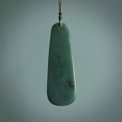 This photo shows a large jade drop shaped pendant. It a a lovely, colourful Inanga jade. The cord is a four plait green and tan colour and is adjustable in length. One only large, contemporary drop necklace from Jade, by Rueben Tipene.