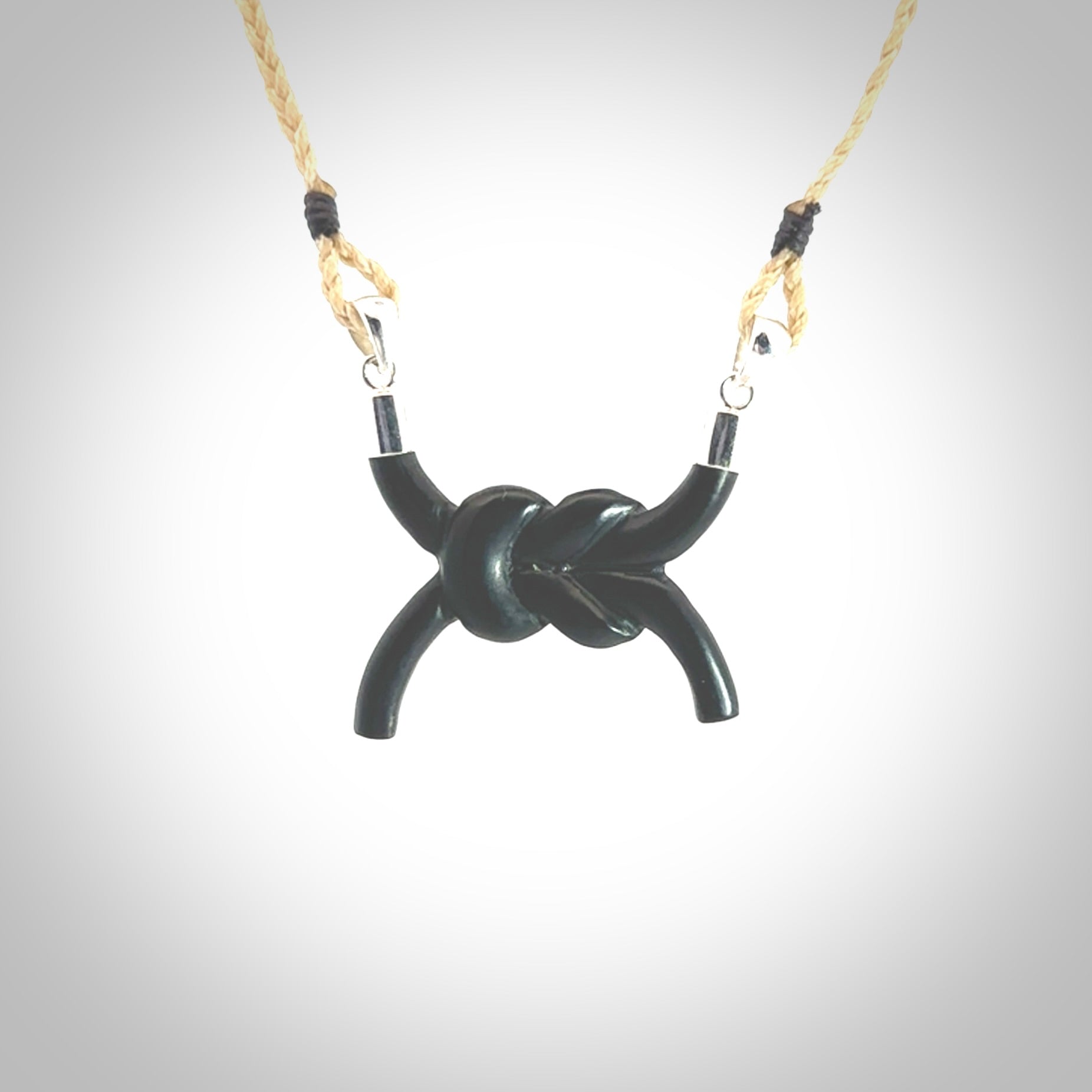 A gorgeous hand carved black jade reef knot pendant with sterling silver. Hand made in Black Jade with Sterling Silver and provided with adjustable cord.