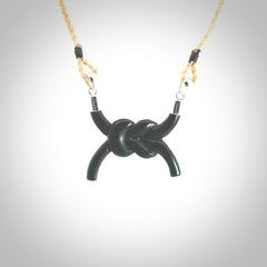 A gorgeous hand carved black jade reef knot pendant with sterling silver. Hand made in Black Jade with Sterling Silver and provided with adjustable cord.