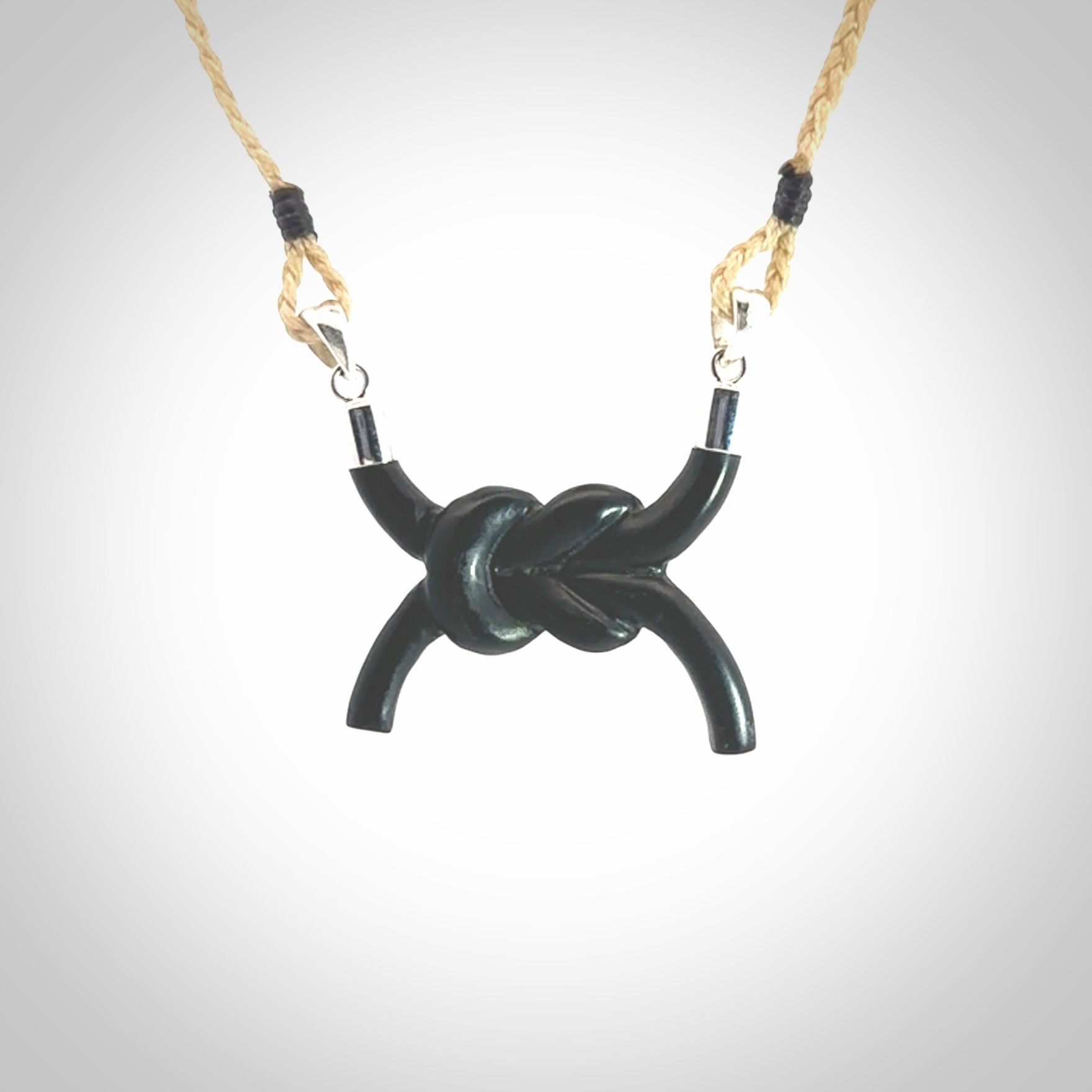 A gorgeous hand carved black jade reef knot pendant with sterling silver. Hand made in Black Jade with Sterling Silver and provided with adjustable cord.