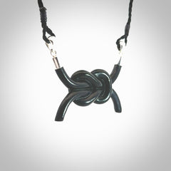 A gorgeous hand carved black jade reef knot pendant with sterling silver. Hand made in Black Jade with Sterling Silver and provided with adjustable cord.