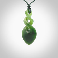 Hand carved New Zealand jade twist pendant. Carved in New Zealand by NZ Pacific. Unique double twist jewellery for sale online. Provided with an adjustable manuka green cord.