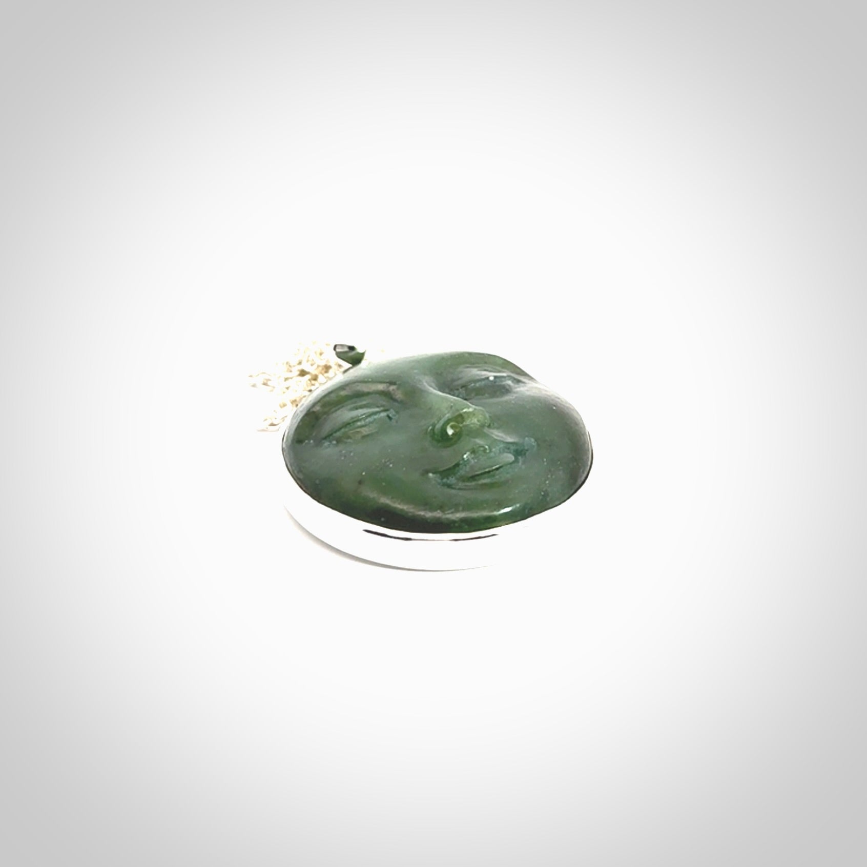 Hand made New Zealand Jade moon face necklace with Sterling Silver. Made by NZ Pacific and sale online only. Delivered with sterling silver chain and packaged in a woven kete pouch.