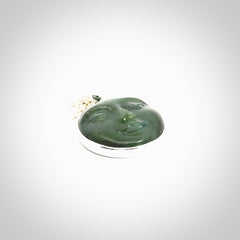 Hand made New Zealand Jade moon face necklace with Sterling Silver. Made by NZ Pacific and sale online only. Delivered with sterling silver chain and packaged in a woven kete pouch.