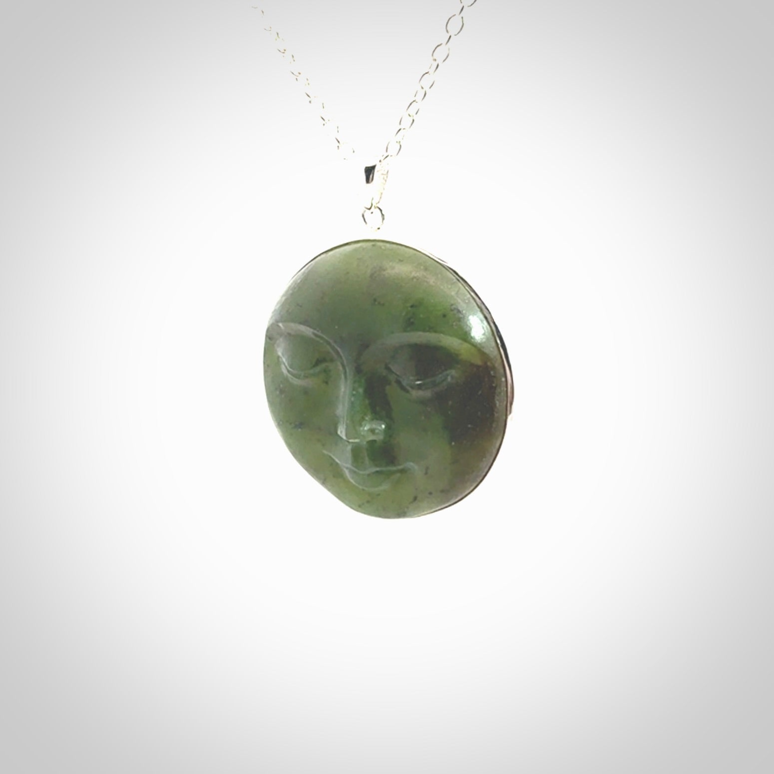 Hand made New Zealand Jade moon face necklace with Sterling Silver. Made by NZ Pacific and sale online only. Delivered with sterling silver chain and packaged in a woven kete pouch.