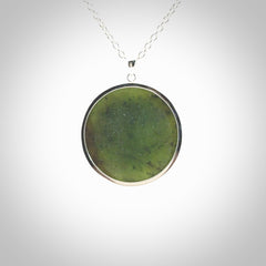 Hand made New Zealand Jade moon face necklace with Sterling Silver. Made by NZ Pacific and sale online only. Delivered with sterling silver chain and packaged in a woven kete pouch.