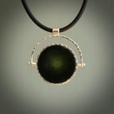A photo of a New Zealand Jade drop pendant with sterling silver. This is a stylish statement piece - hand crafted here in New Zealand by Ana Krakosky. Unique Art to Wear. Gifts for all lovers of hand made Art to Wear. One only Fidget pendant.