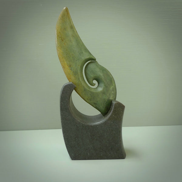 Hand carved New Zealand Flower Jade koru with Greywacke stand sculpture. Hand carved in New Zealand by Ric Moor. This is a one only sculpture and is a beautiful, large, display piece.