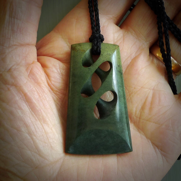 Hand carved New Zealand jade, complex twist pendant. Hand made complex twist pendant hand carved in New Zealand. Made by NZ Pacific, jade jewellery for sale online. One only hand made by Kerry Thompson.