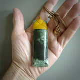 A large and beautiful hand carved toki pendant. This piece is carved from New Zealand flower jade by NZ Pacific. This is a wonderful large toki bound with a tan cord and a traditional lashing. A beautiful, traditional toki for sale online.
