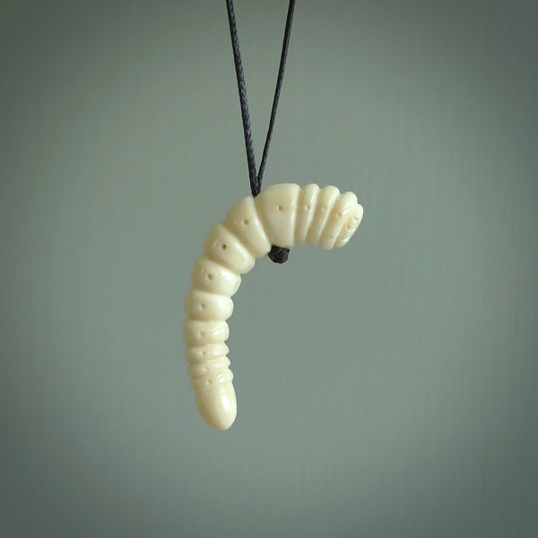 Hand carved huhu bug  pendant, carved for us by Fumio Noguchi. This piece is carved from bone and is a fantastic depiction of these bugs. This particular piece is a huhuh bug design and is lovingly carved. Free shipping worldwide.