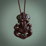 This is a medium sized tiki - carved from gorgeous red Jasper Stone. The craftsmanship is superb, this piece is as well carved as any we have seen. The cord is an adjustable plaited cord in Wapiti Brown and Burgundy.