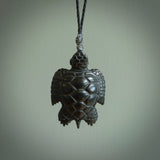 This picture shows a hand carved black jade turtle pendant. It is polished to a soft shine and has quite a lot of detail carved into the jade. The cord is a hand plaited black, waxed polyester. Carved by NZ Pacific.