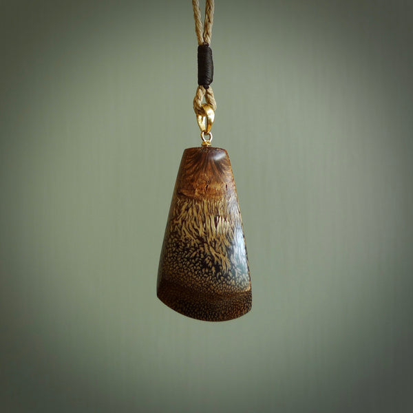 This is a medium sized, hand carved toki pendant. It is made from banksia wood. This is a medium sized Toki and very unique, one only, pendant that is a collectors piece. Hand carved by New Zealand artist, Sami.