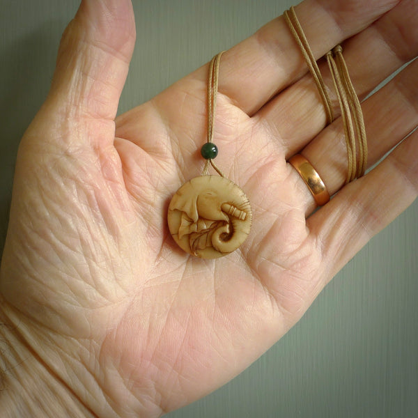This is a hand carved elephant pendant. It is made from Tigara nut. This is a small sized necklace and is a very unique, one only, pendant that is a collectors piece. Hand carved by New Zealand artist, Sami.