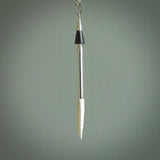 Hand carved arrow made from bone and sterling silver - this is a pendant provided with a sterling silver chain. NZ Pacific pendant for sale online. Hand made archers arrow necklace with sterling silver. One only art to wear.