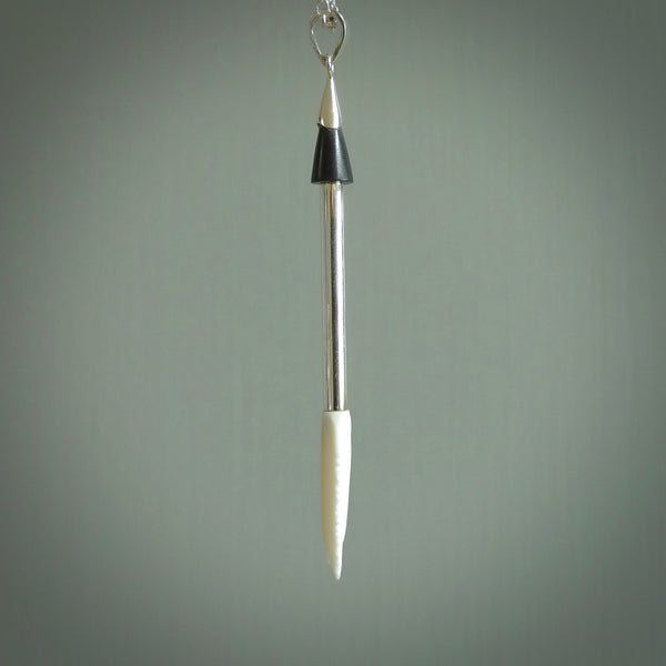 Hand carved arrow made from bone and sterling silver - this is a pendant provided with a sterling silver chain. NZ Pacific pendant for sale online. Hand made archers arrow necklace with sterling silver. One only art to wear.