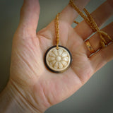 Hand carved natural bone with buffalo horn contemporary disc pendant with creative and unique carvings on the front face of each individual piece. Delivered with an adjustable cord.