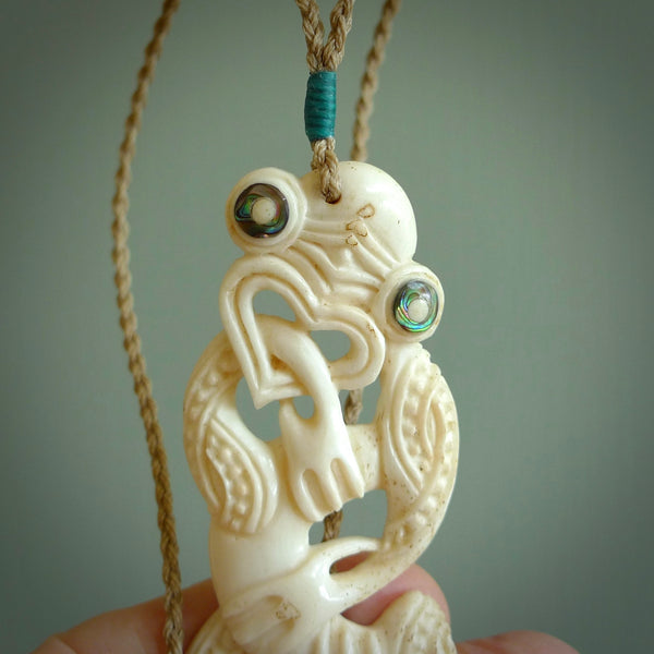 Hand carved large bone Tiki pendant. Traditional art hand carved for NZ Pacific. Bone Tiki necklace with Paua Shell eyes.