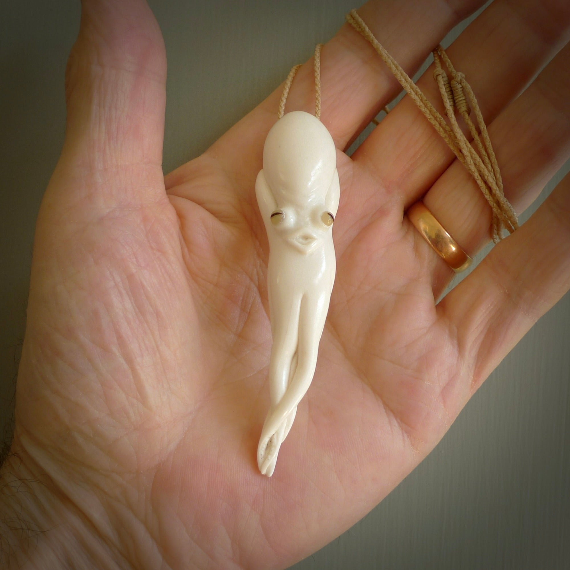 Hand carved octopus pendant in resting pose. This piece has been carved in incredible detail from bone. The artist is Fumio Noguchi, a renowned New Zealand bone carver who carves pieces for NZ Pacific. These unique bone pendants are for sale online at nzpacific.com One only collectors item for lovers of the ocean and octopus.