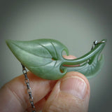 This photo shows a lily leaf drop pendant suspended from a silver clasp and silver chain. The jade is a lovely light flower jade and is a 3D lily design. A lovely soft New Zealand jade pendant carved for us by Josey Coyle.