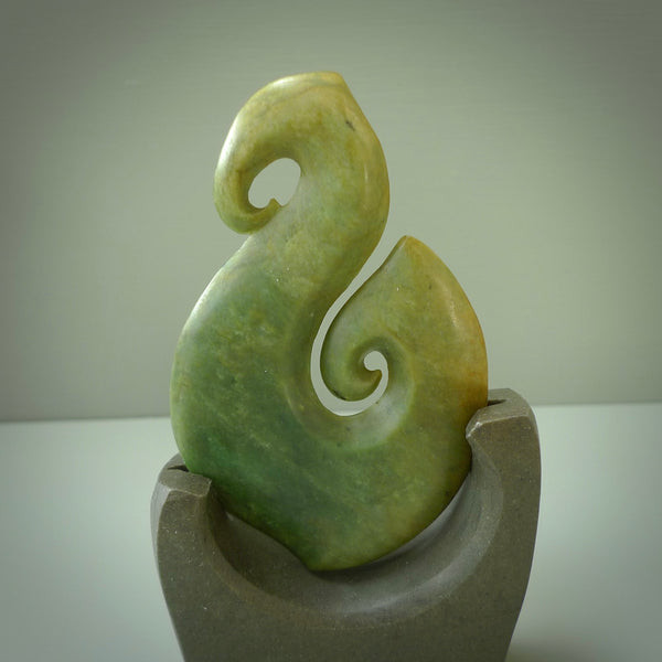 Hand carved New Zealand Flower Jade Hook with Greywacke stand sculpture. Hand carved in New Zealand by Ric Moor. This is a one only sculpture and is a beautiful, large, display piece.