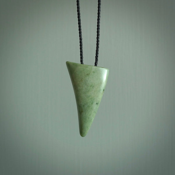 This is a lovely New Zealand Jade, pounamu drop pendant. Hand carved for us by Ric Moor. It is bound with an adjustable black coloured cord which is length adjustable. Free worldwide shipping.