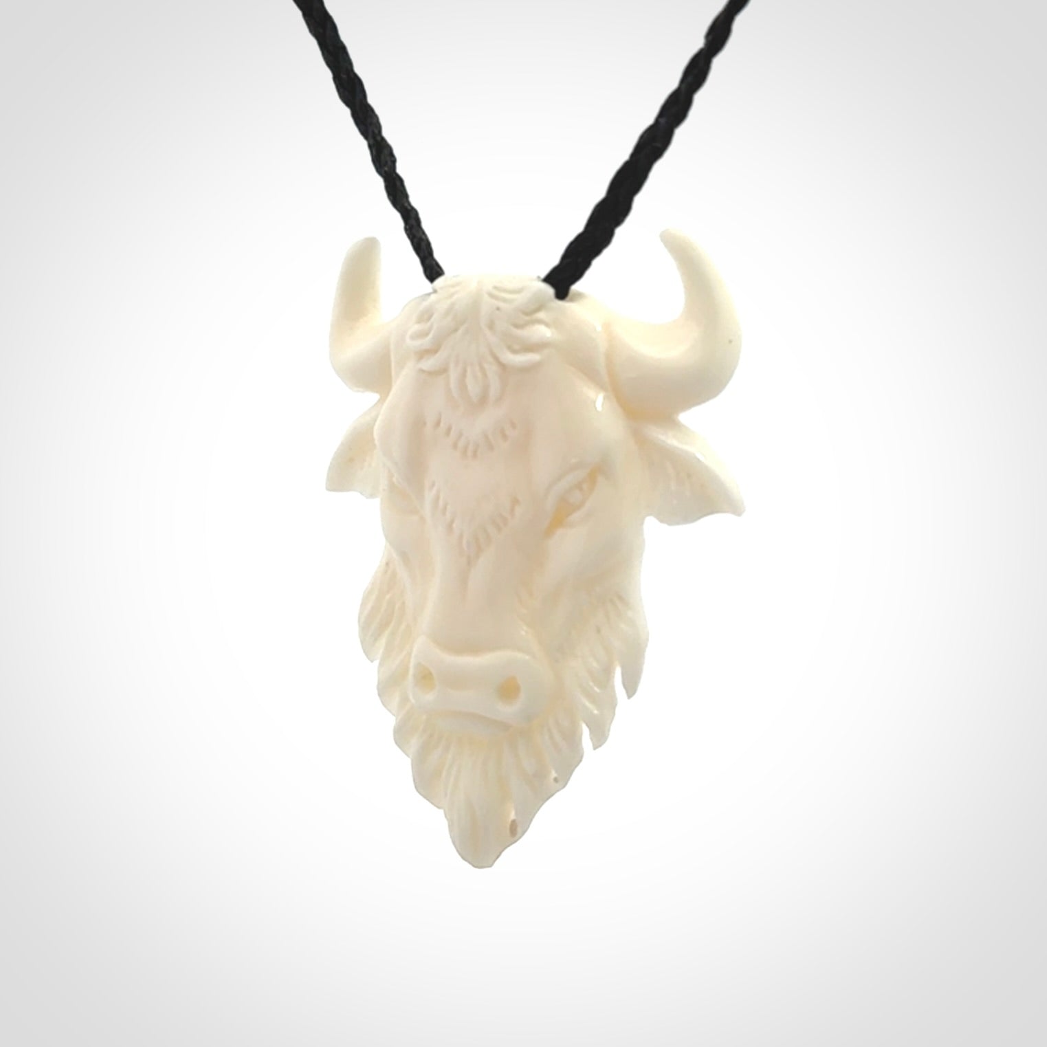 Hand carved bone bull pendant.