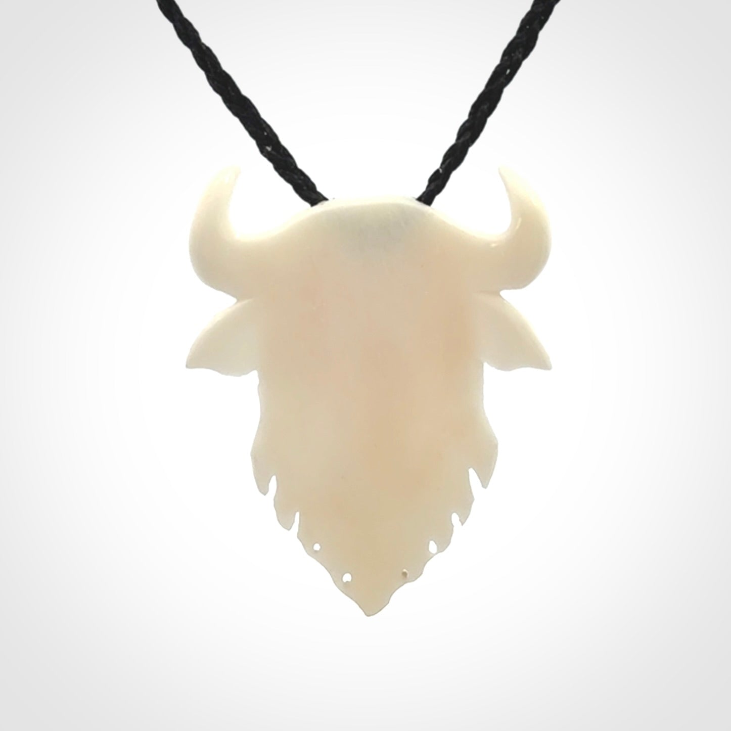 Hand carved bone bull pendant.