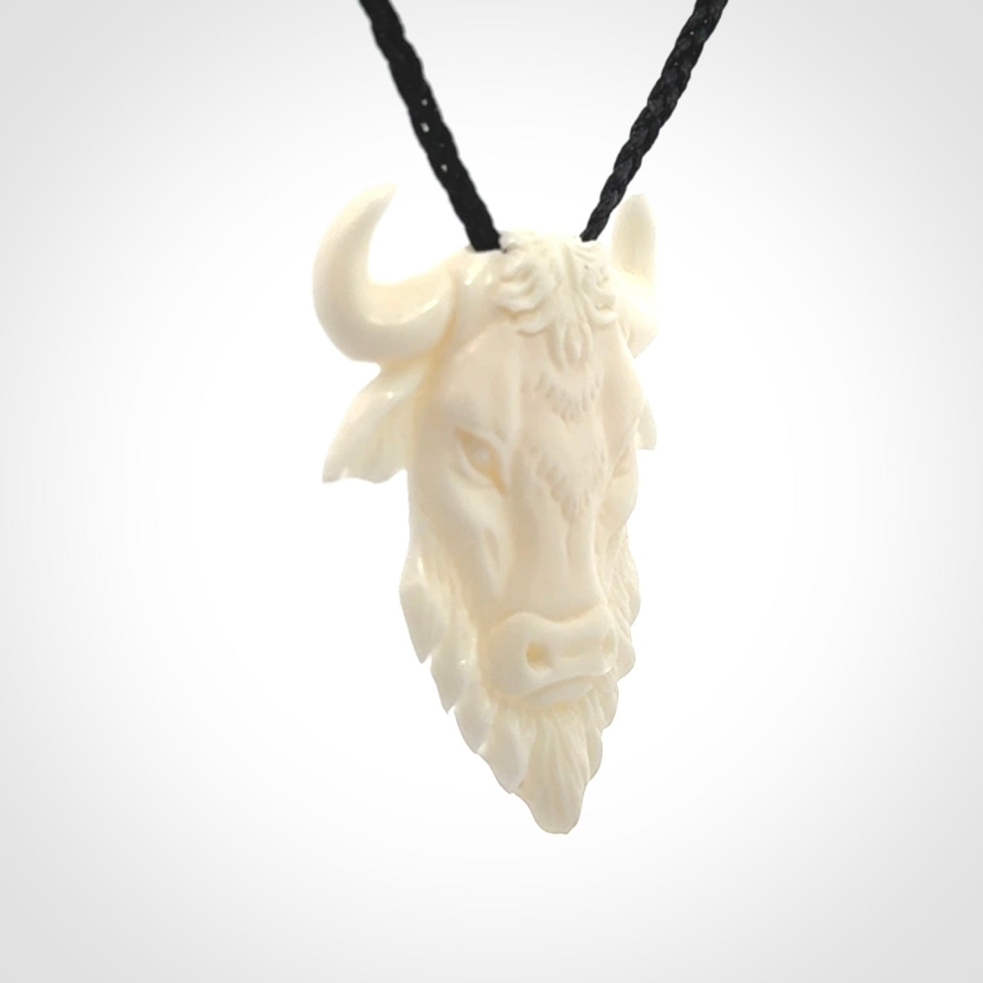 Hand carved bone bull pendant.