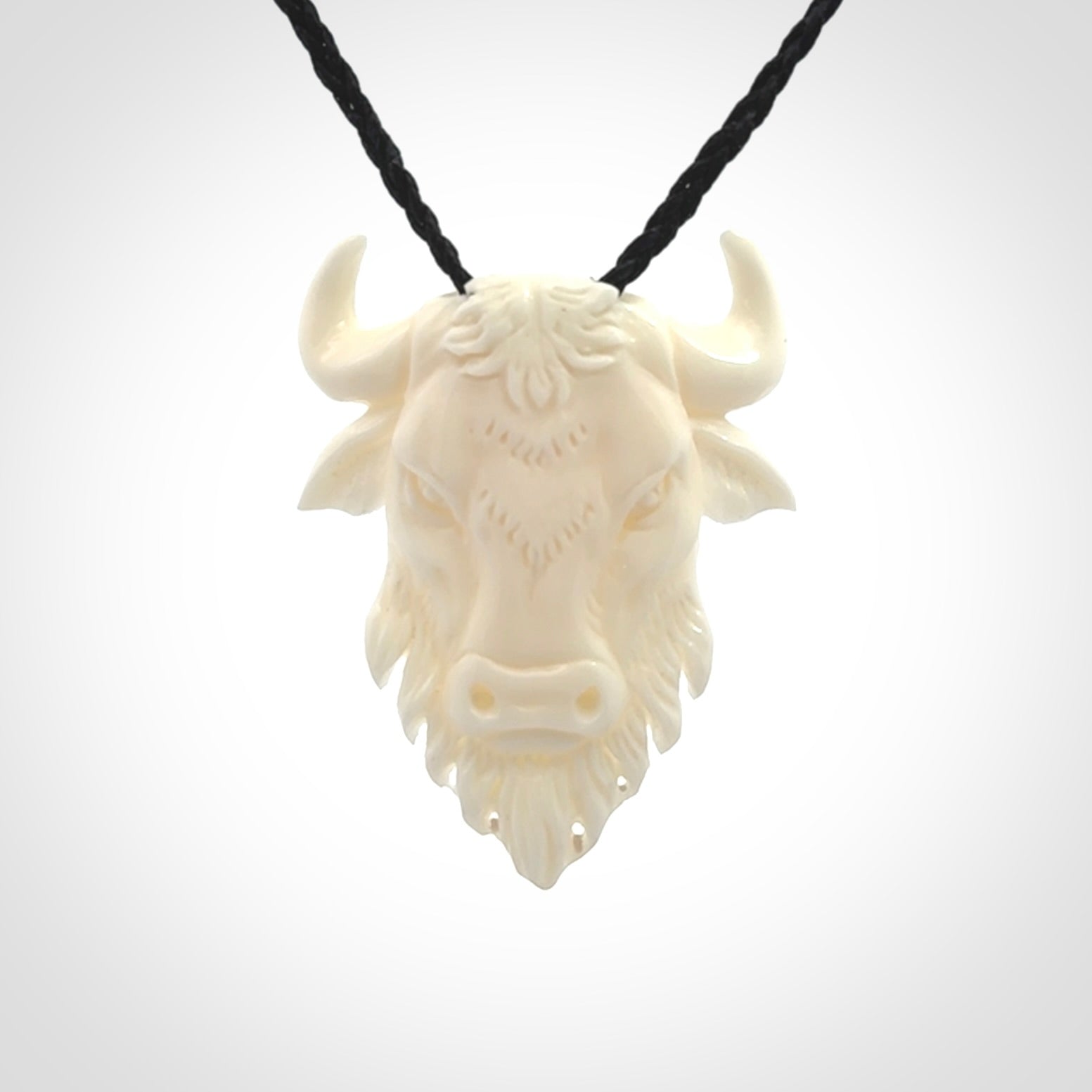 Hand carved bone bull pendant.