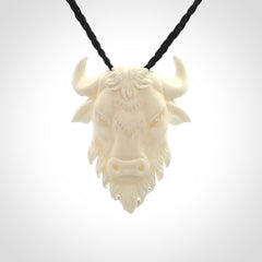 Hand carved bone bull pendant.