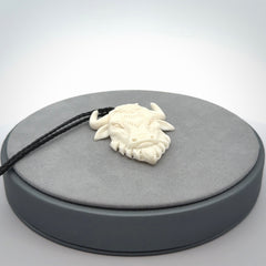 Hand carved bone bull pendant.