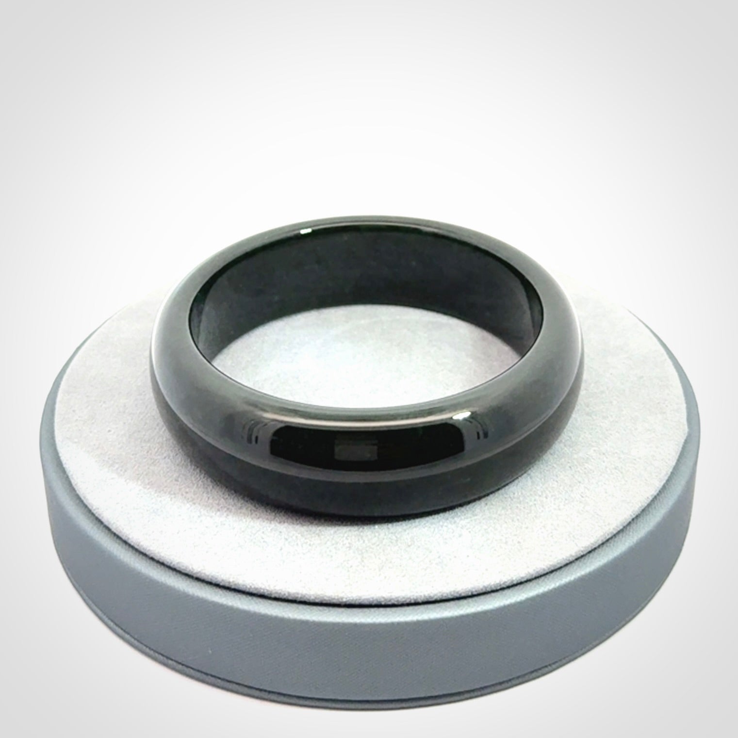 Hand carved black jade bangle. Carved from black jade. This is a solid jade bangle carved from a single piece of jade. It is polished to a soft shine. The jade is otherwise untreated and completely natural.