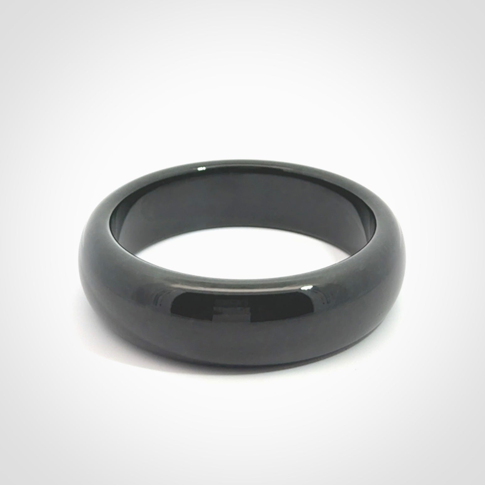 Hand carved black jade bangle. Carved from black jade. This is a solid jade bangle carved from a single piece of jade. It is polished to a soft shine. The jade is otherwise untreated and completely natural.