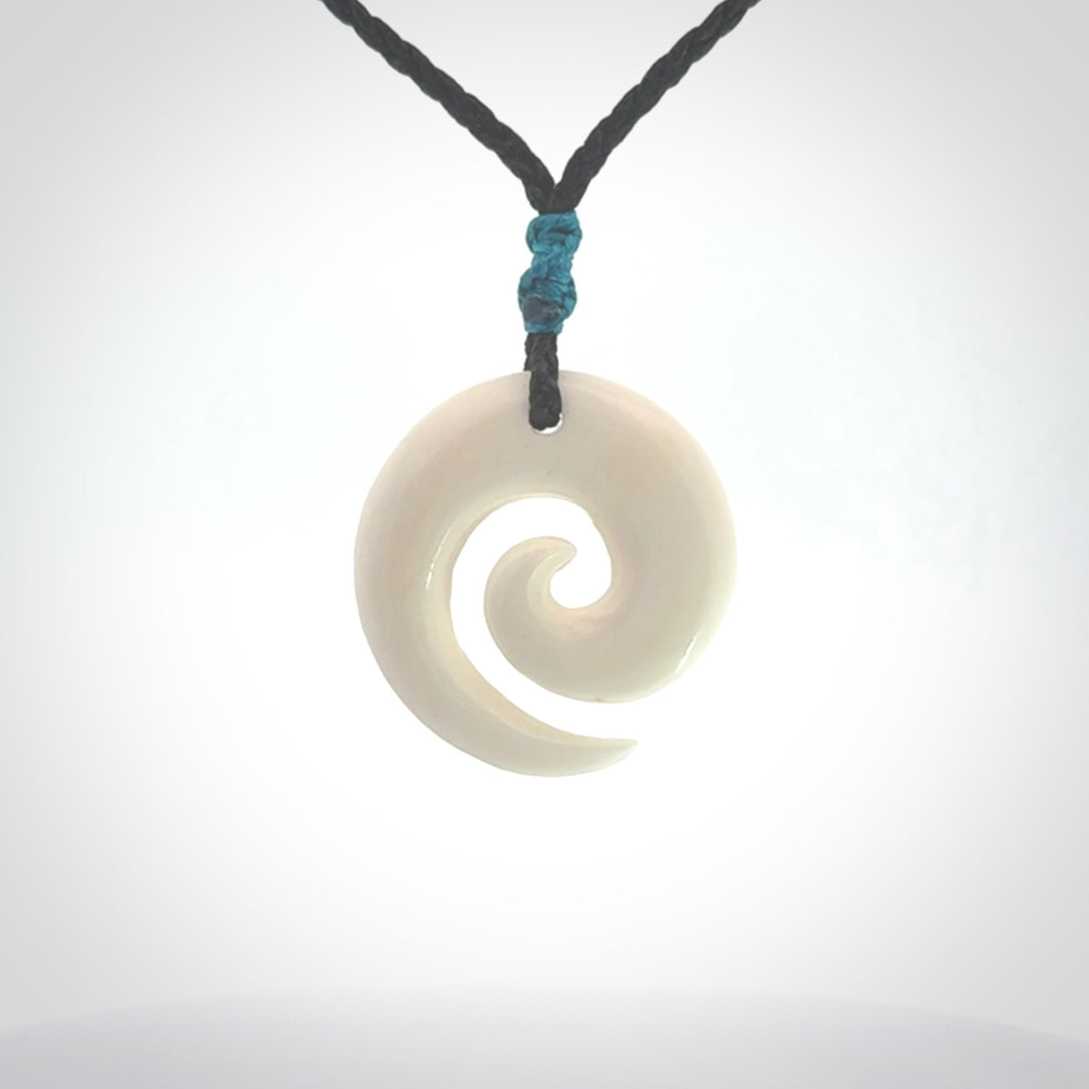 Hand carved natural bone koru pendant. Made by NZ Pacific.