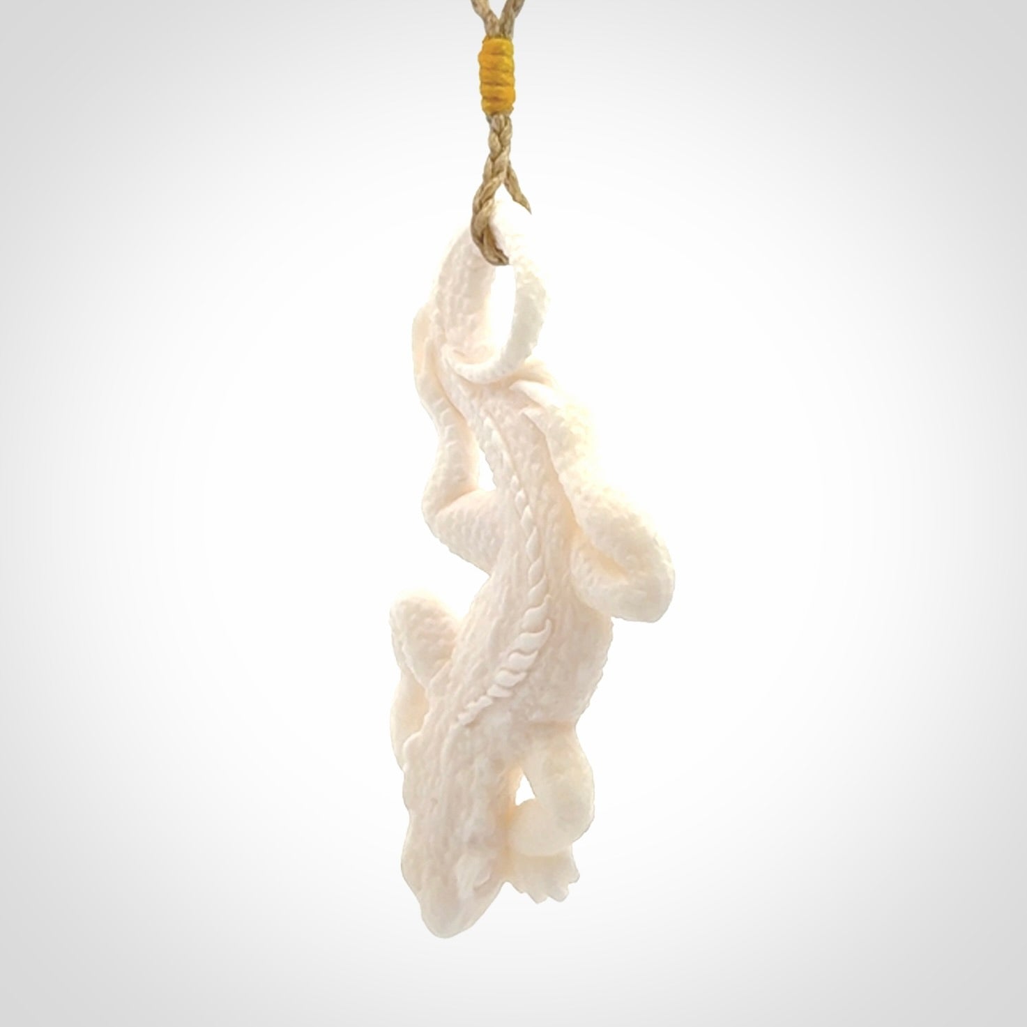 Hand carved bone Tuatara pendant.